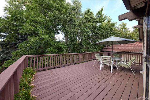 2141 S Dallas St, Denver, CO 80231 - deck featuring outdoor dining space and view of wooded area