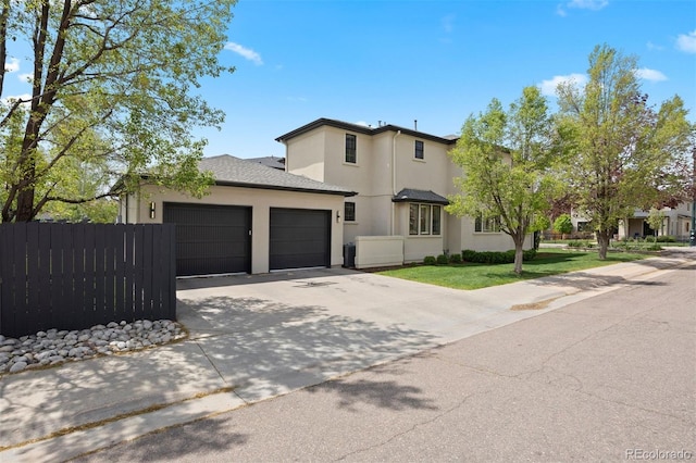 traditional home with stucco siding, a garage, and concrete driveway