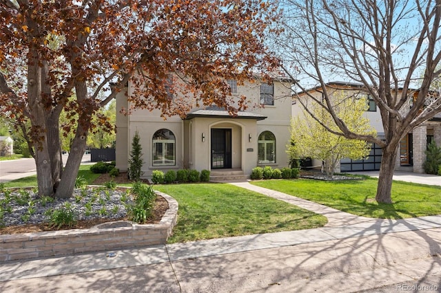 mediterranean / spanish house featuring stucco siding, concrete driveway, and a front yard
