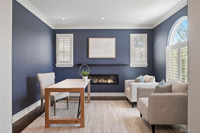 office with crown molding, a glass covered fireplace, wood finished floors, baseboards, and recessed lighting