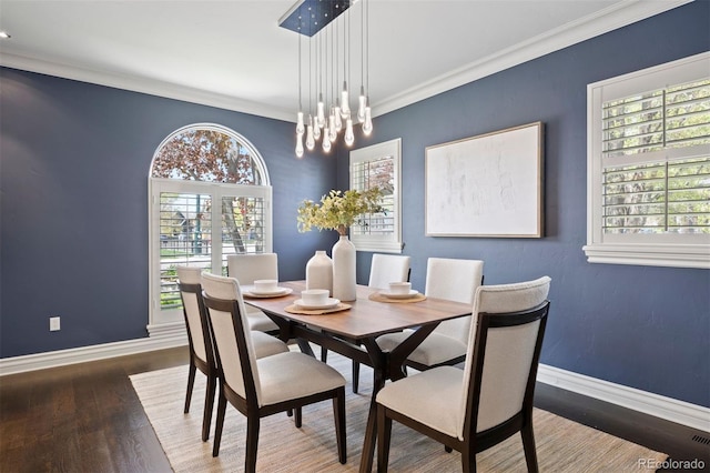 dining space featuring baseboards, plenty of natural light, and crown molding
