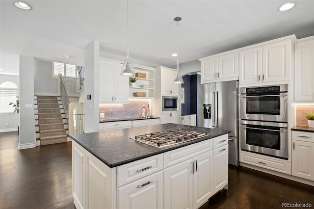 kitchen featuring stainless steel appliances, dark countertops, recessed lighting, open shelves, and dark wood-type flooring