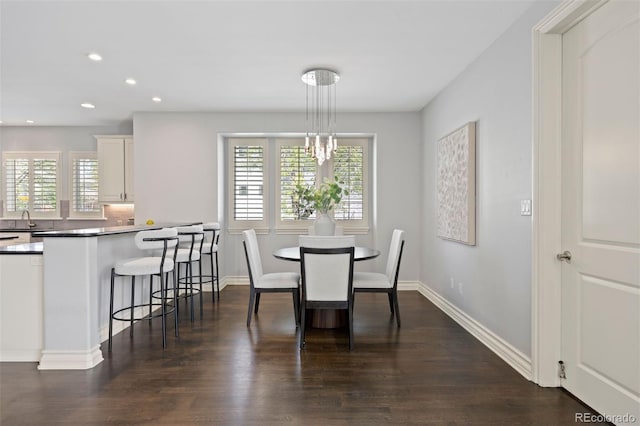 dining space with dark wood finished floors, recessed lighting, and baseboards