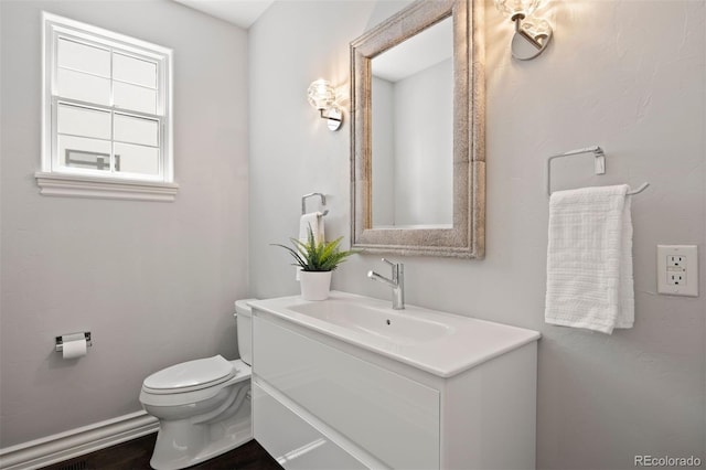 bathroom with toilet and vanity