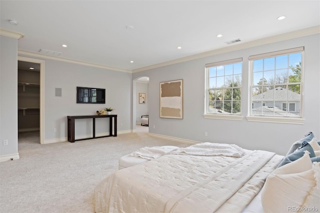bedroom featuring arched walkways, light colored carpet, baseboards, recessed lighting, and ornamental molding