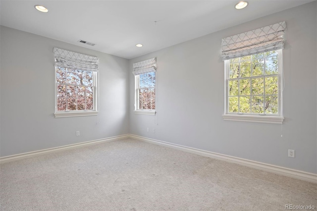 spare room featuring recessed lighting, baseboards, and carpet flooring