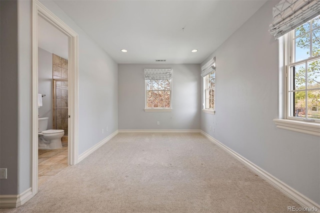 unfurnished bedroom with multiple windows, carpet, recessed lighting, and baseboards