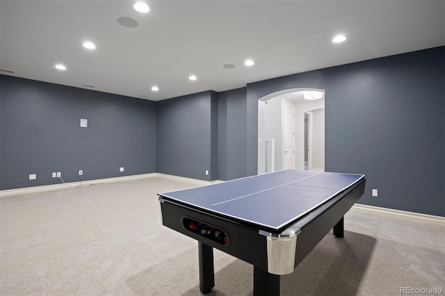recreation room featuring arched walkways, carpet, recessed lighting, and baseboards