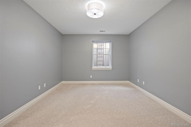 unfurnished room with carpet floors and baseboards
