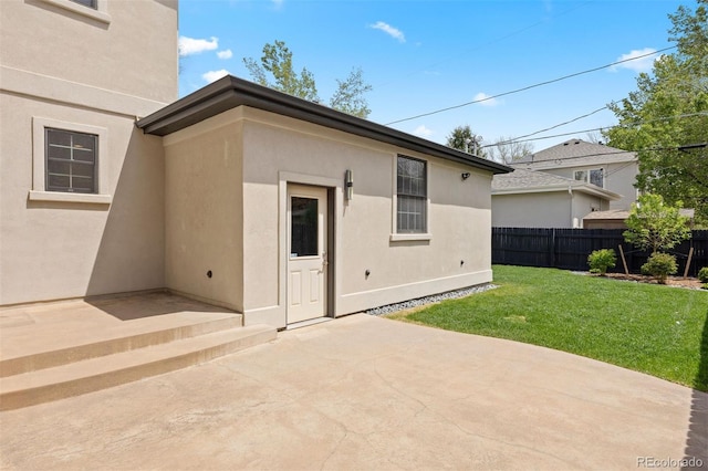 rear view of property featuring a patio area and stucco siding