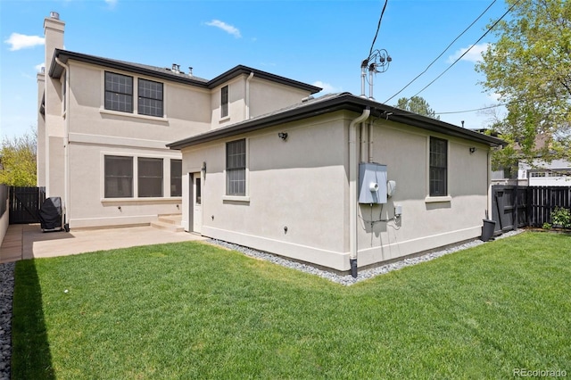2500 S Monroe St, Denver, CO 80210 - back of property featuring a chimney, stucco siding, and a patio
