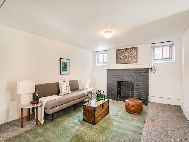 living area with a brick fireplace, carpet flooring, and plenty of natural light