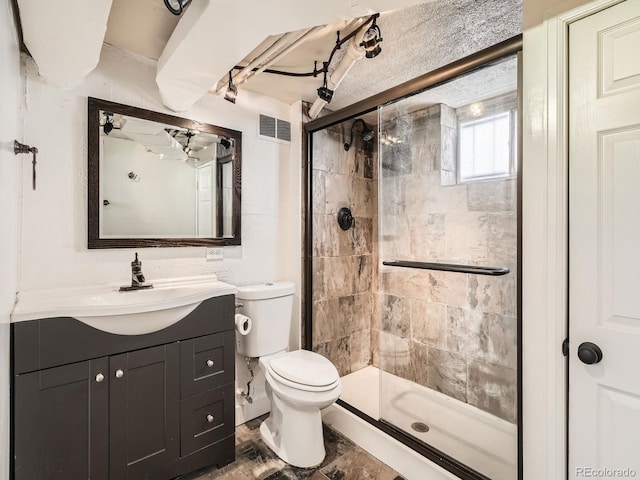 bathroom with toilet, a shower stall, visible vents, and vanity