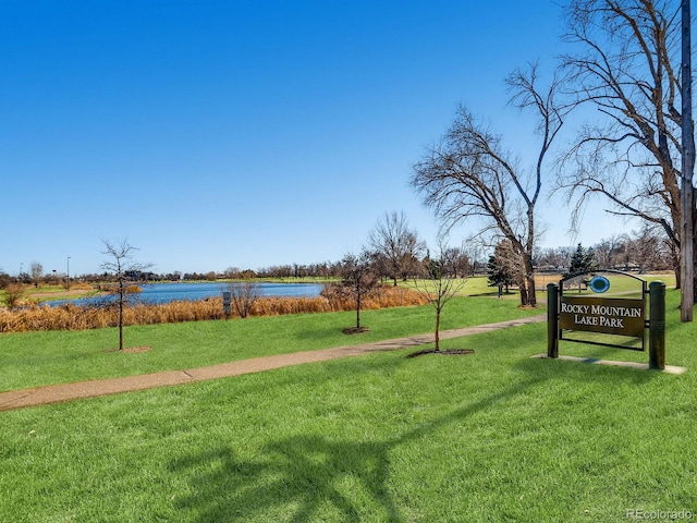 view of home's community with a yard and a water view