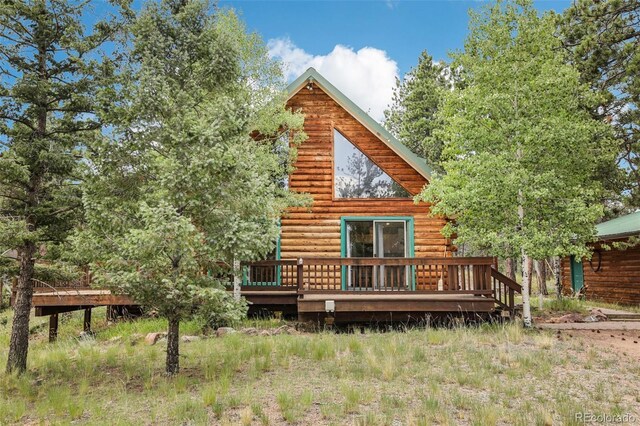 rear view of property with a wooden deck