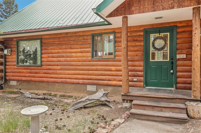 entrance to property featuring crawl space, visible vents, and metal roof