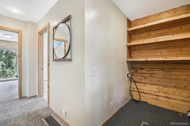 hall with carpet flooring and visible vents