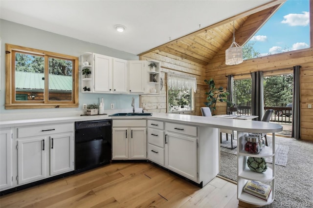 kitchen with dishwasher, lofted ceiling, a peninsula, white cabinetry, and open shelves