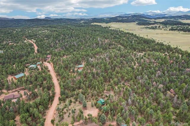 aerial view featuring a forest view and a mountain view