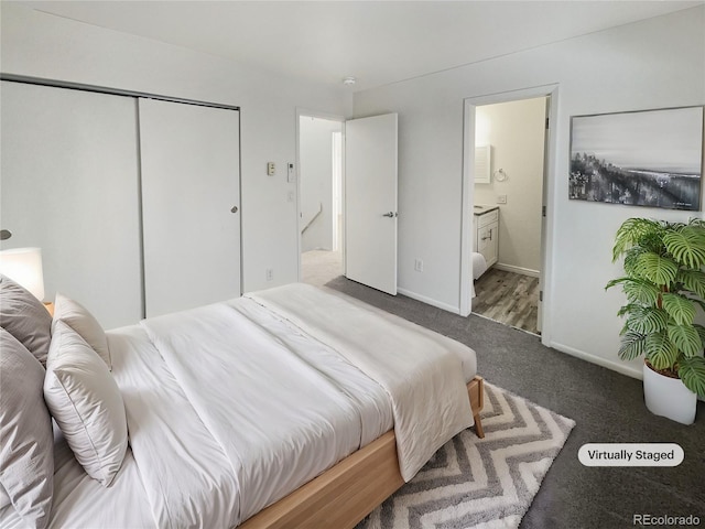 carpeted bedroom with ensuite bath and a closet