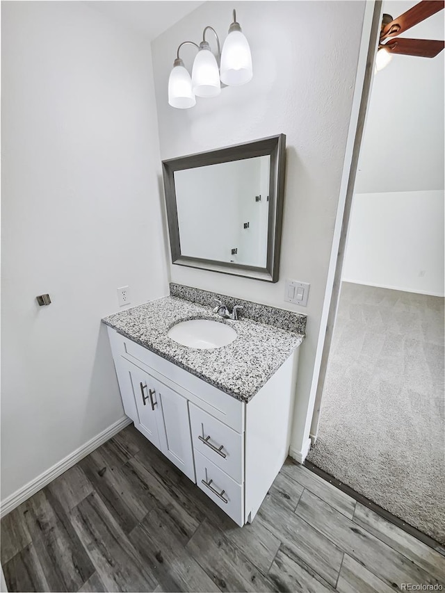 bathroom featuring hardwood / wood-style floors, vanity, and ceiling fan