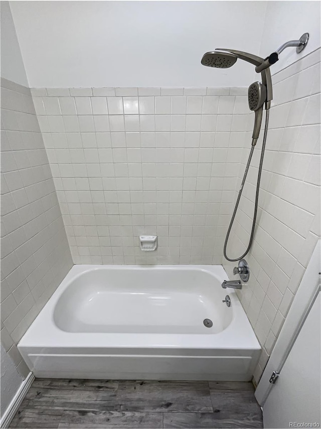 bathroom featuring hardwood / wood-style floors and tiled shower / bath combo