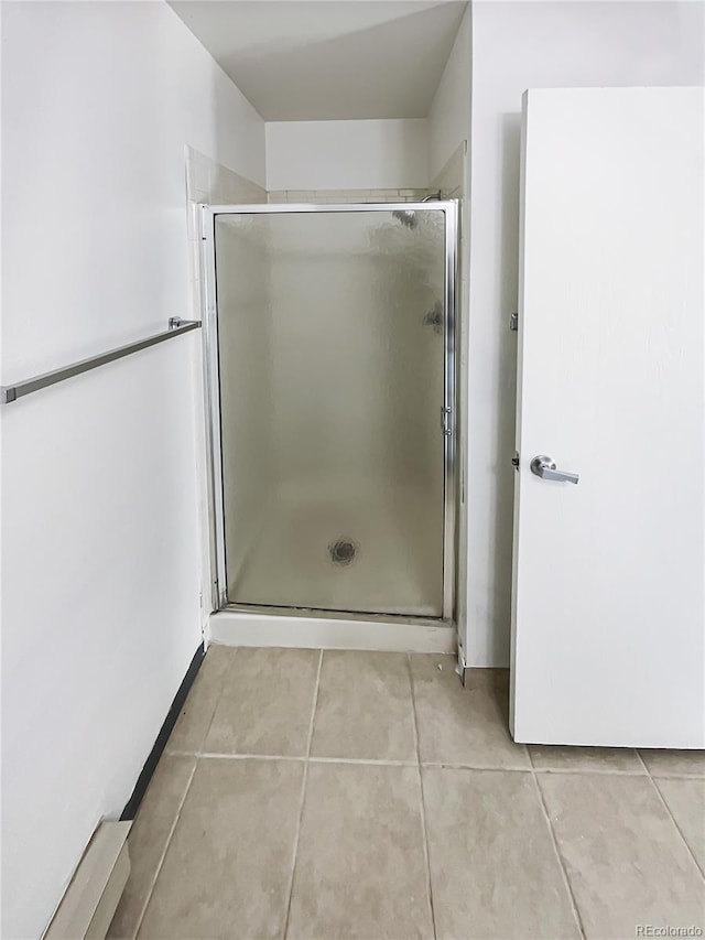 bathroom featuring tile patterned floors and an enclosed shower