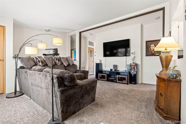 living area featuring visible vents and carpet floors