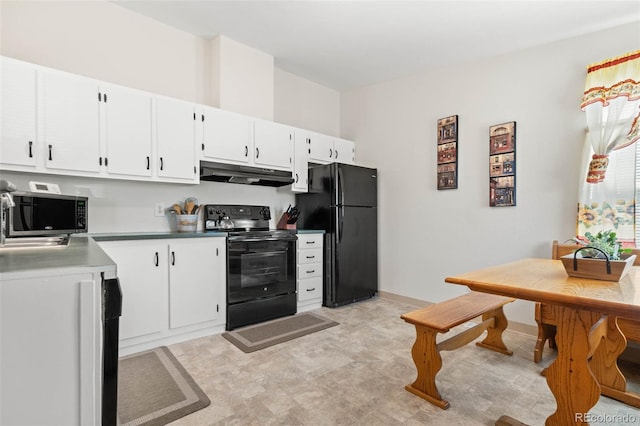 kitchen with under cabinet range hood, baseboards, black appliances, and white cabinets