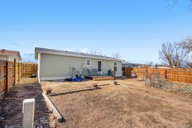 back of house featuring a fenced backyard