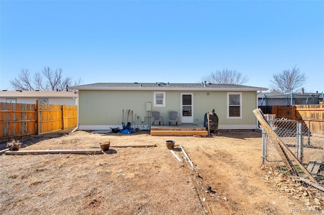 back of property featuring a fenced backyard