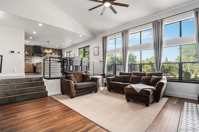 living area with a healthy amount of sunlight, stairs, and wood finished floors