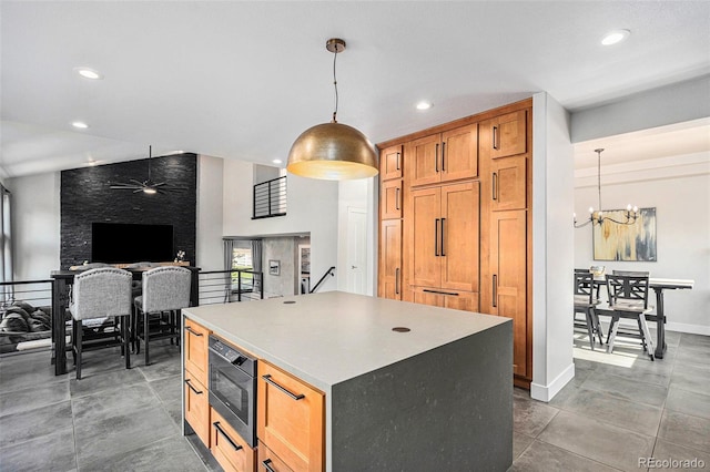 10731 E 151st Pl, Brighton, CO 80602 - kitchen featuring built in microwave, a kitchen island, a chandelier, recessed lighting, and pendant lighting