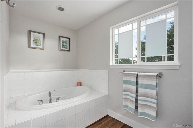 10731 E 151st Pl, Brighton, CO 80602 - bathroom with wood finished floors, a garden tub, and baseboards