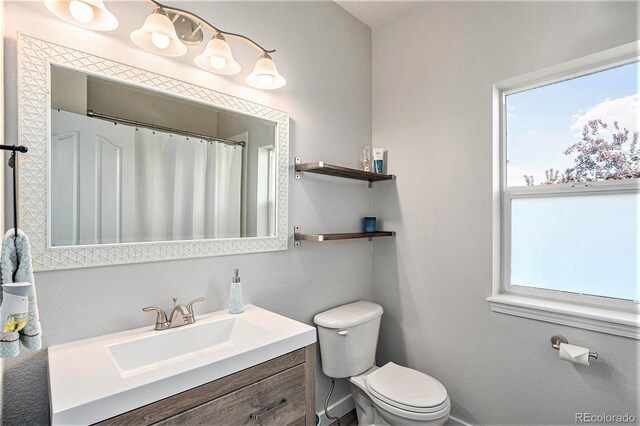 10731 E 151st Pl, Brighton, CO 80602 - bathroom with toilet, vanity, and curtained shower