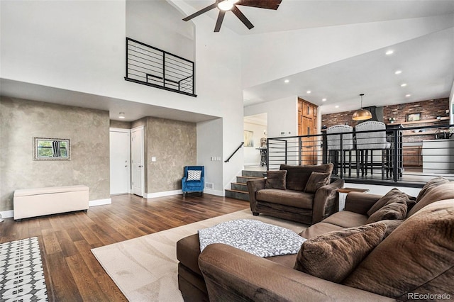 10731 E 151st Pl, Brighton, CO 80602 - living room featuring a ceiling fan, wood-type flooring, stairway, baseboards, and high vaulted ceiling