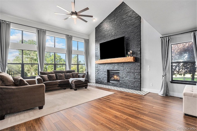 10731 E 151st Pl, Brighton, CO 80602 - living area featuring ceiling fan, a fireplace, wood finished floors, and high vaulted ceiling