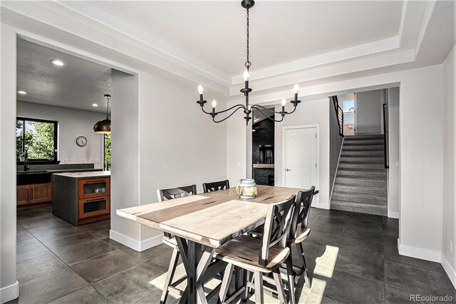 10731 E 151st Pl, Brighton, CO 80602 - dining space featuring stairs, a chandelier, baseboards, a tray ceiling, and recessed lighting