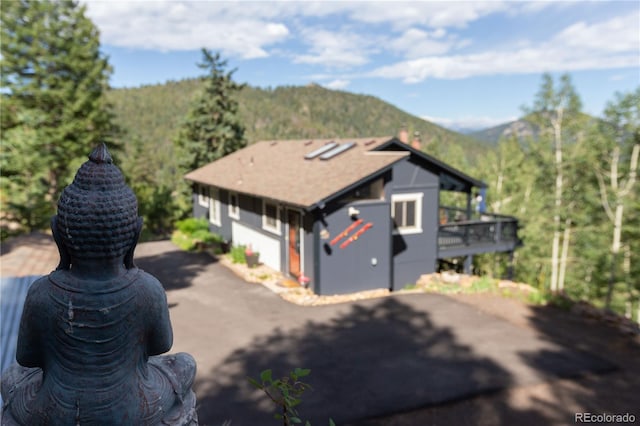 view of side of home featuring a mountain view