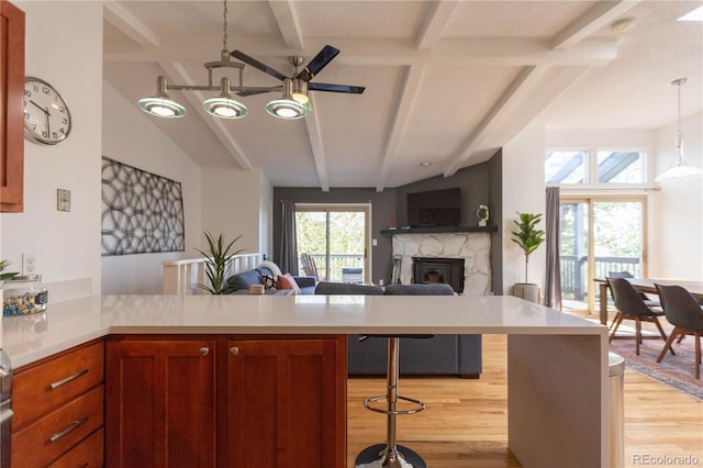 kitchen with light countertops, a peninsula, and beam ceiling