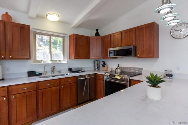 kitchen featuring stainless steel appliances, brown cabinetry, beamed ceiling, and a sink