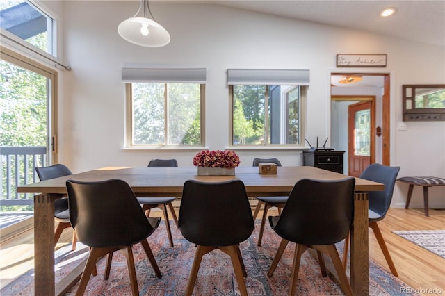dining area featuring vaulted ceiling, wood finished floors, and recessed lighting