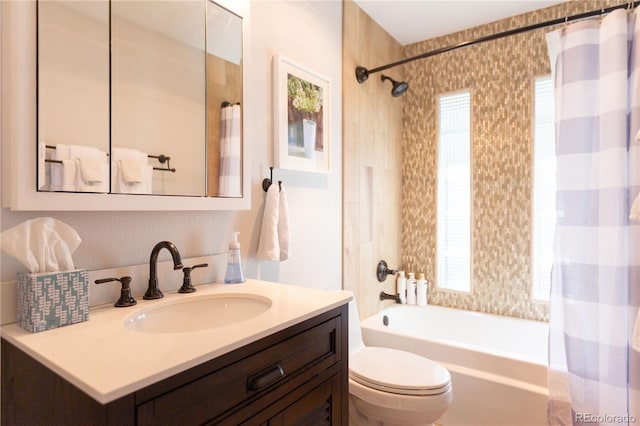 bathroom featuring shower / bath combo with shower curtain, toilet, a wealth of natural light, and vanity