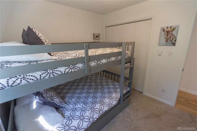bedroom featuring carpet flooring, baseboards, and a closet