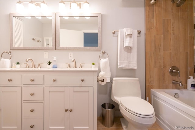 full bath with toilet, double vanity, a sink, and tub / shower combination