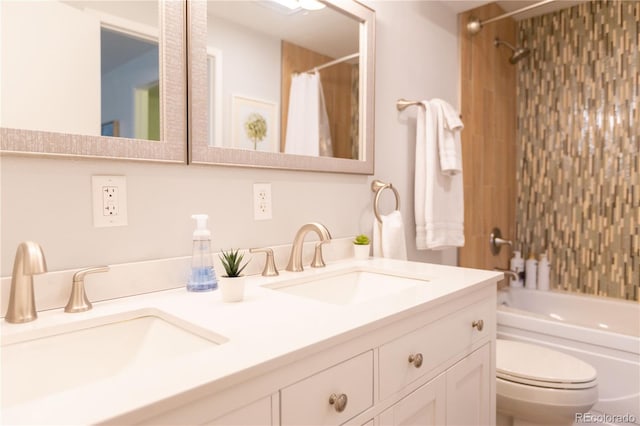 bathroom featuring toilet, double vanity, a sink, and shower / bathtub combination with curtain