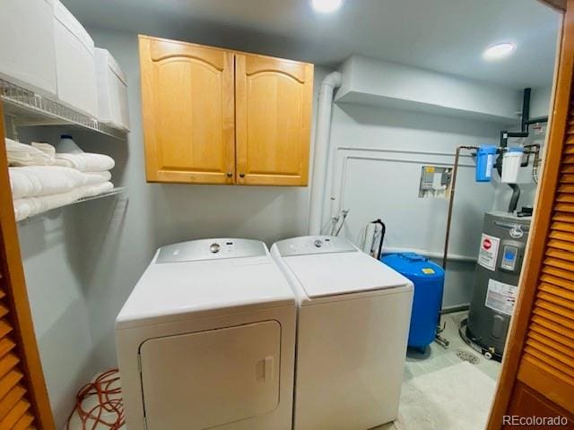 washroom featuring independent washer and dryer, cabinet space, recessed lighting, and electric water heater