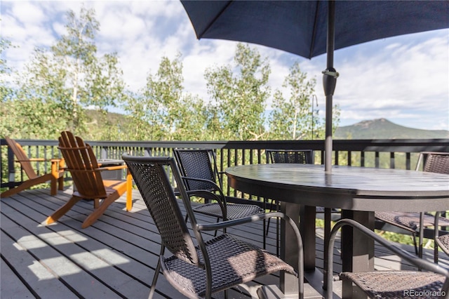wooden terrace with outdoor dining space