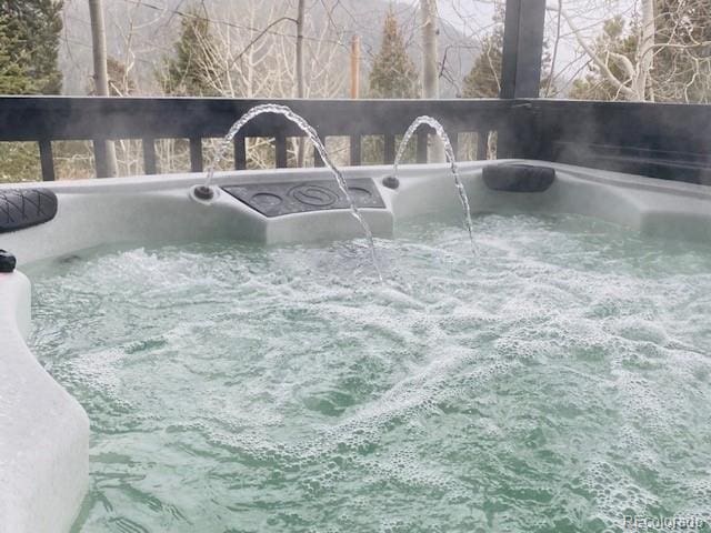 view of swimming pool with a hot tub