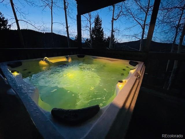 view of pool with a hot tub